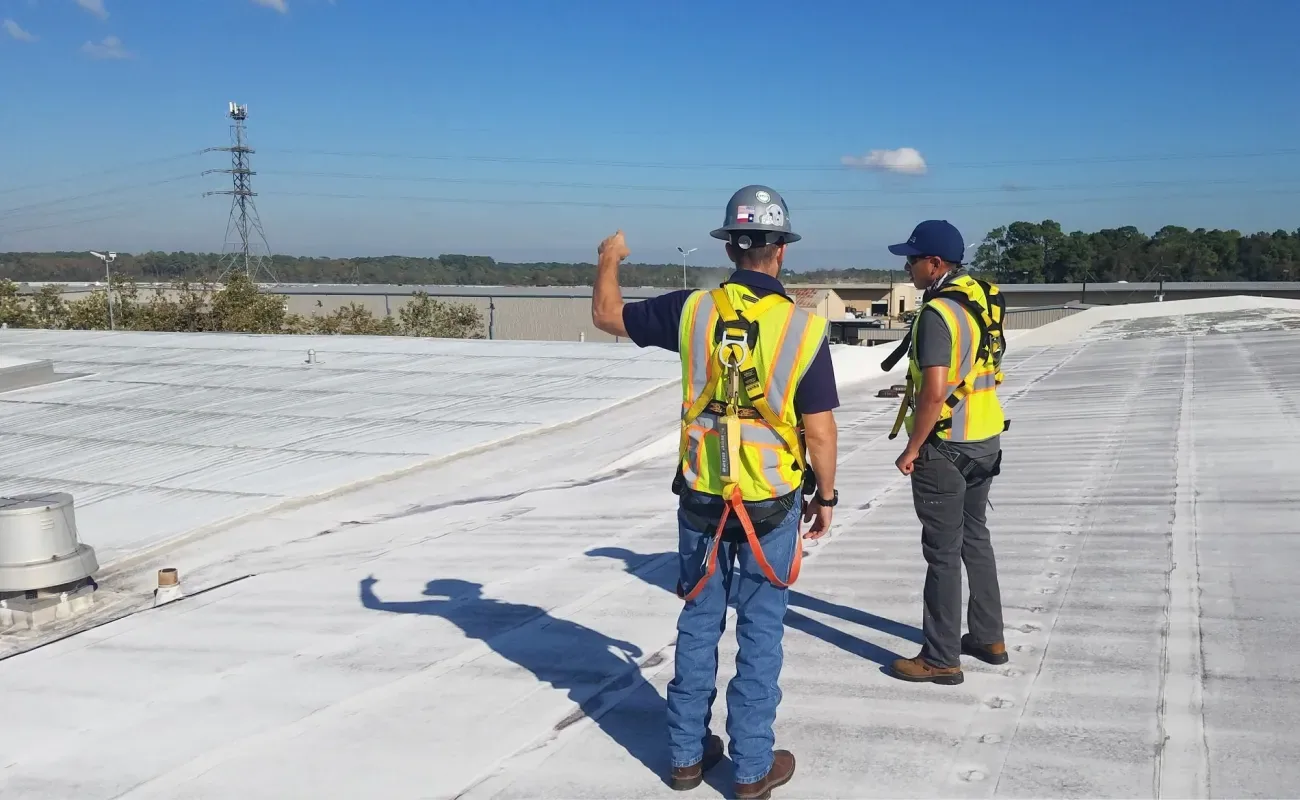 Roof assessment crew on a low-slope roof